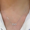 Collana con infinito in oro bianco e diamanti