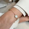 Bracciale in argento con saponette in zirconi e madreperla tonda